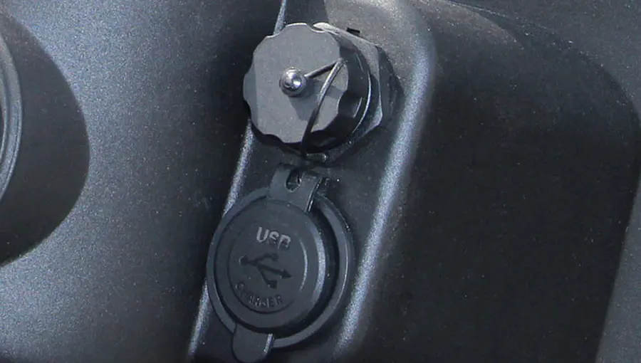 Close-up of USB charging port installed on Tara medium speed vehicle dashboard, enabling easy device charging on the go