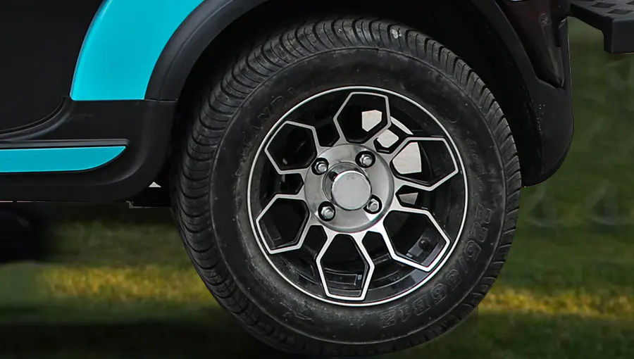 Close-up of Tara medium speed vehicle 12-inch aluminum wheel paired with a radial tire, offering strength and smooth ride performance