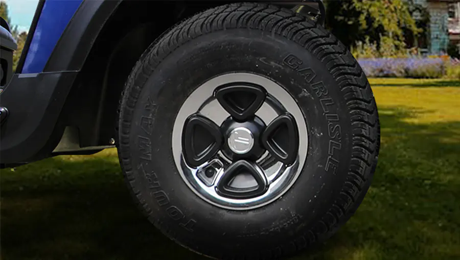 Close-up of 8-inch lawn tires on Tara medium speed vehicle, designed for optimal traction and minimal turf damage