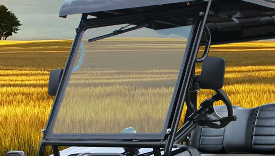 Close-up of the one-piece windshield on Tara Turfman 700 EEC, designed to provide clear visibility and protection from wind and debris